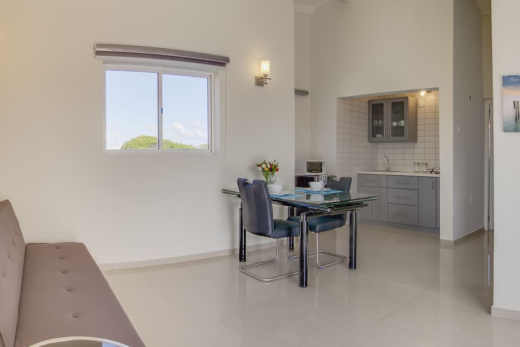 Modern and clean living room with open kitchen.