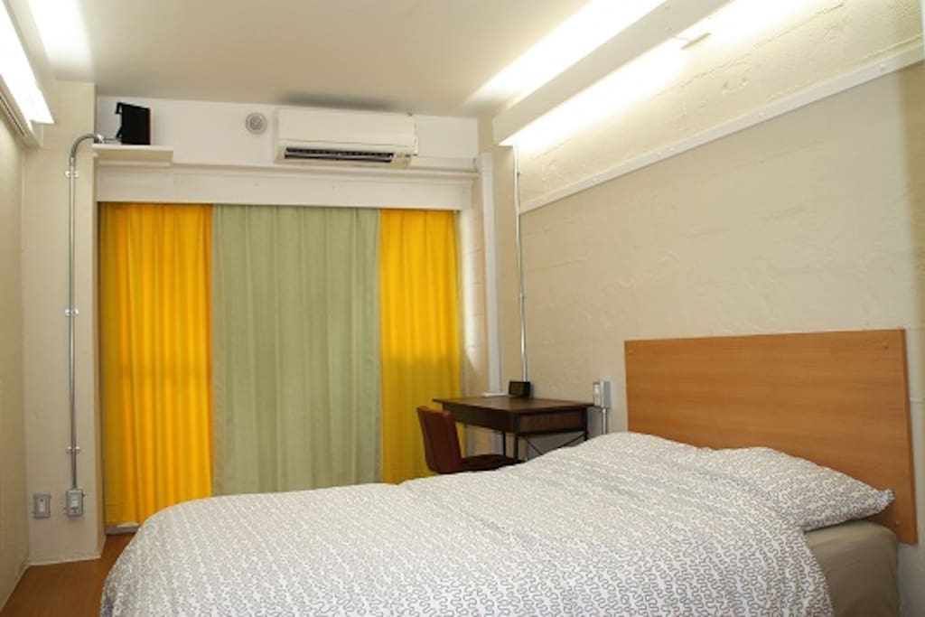 Bedroom with lights on from hallway