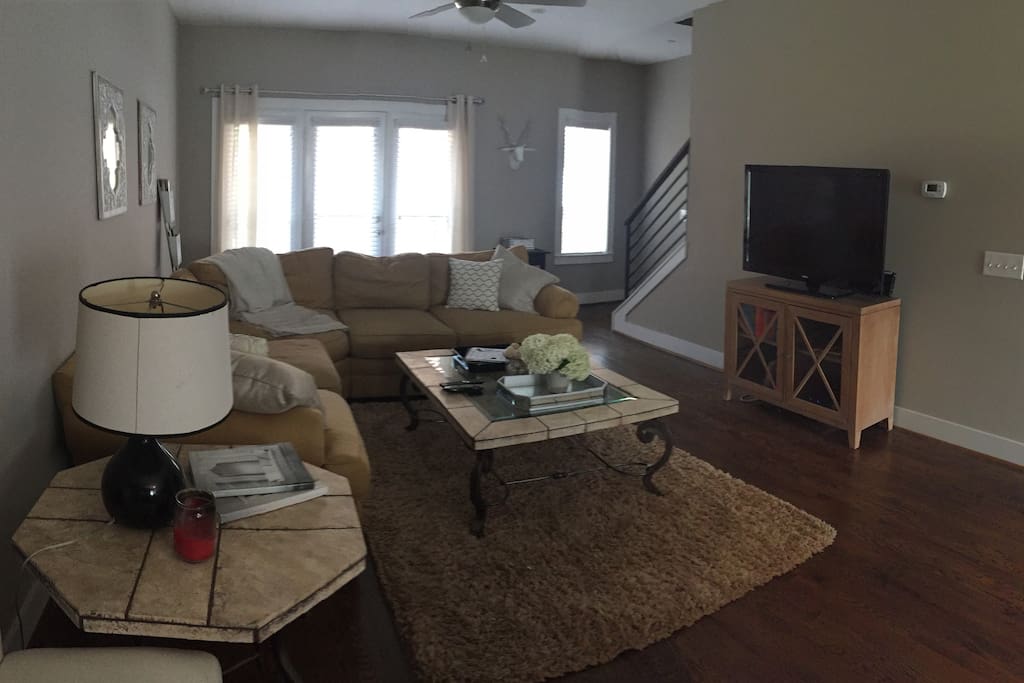 Living room also has a large flat-screen tv with cable.