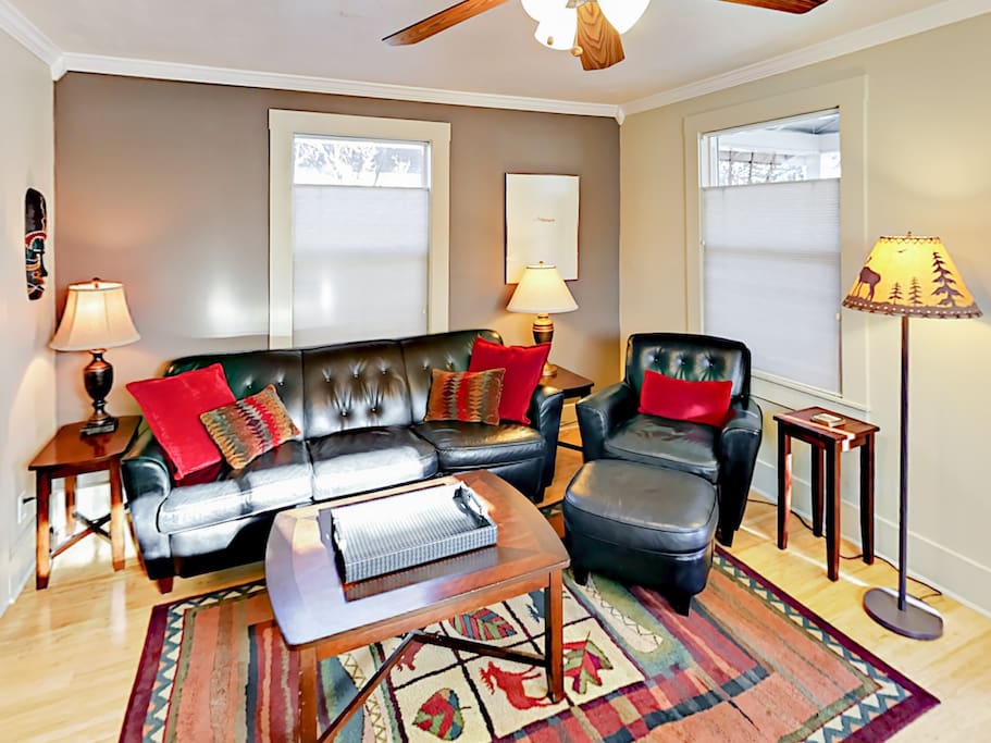The welcoming living room includes seating for 4.