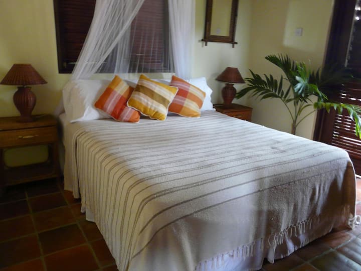 Bedroom with Queen size bed and good size closet, has ceiling and floor fan for your comfort.