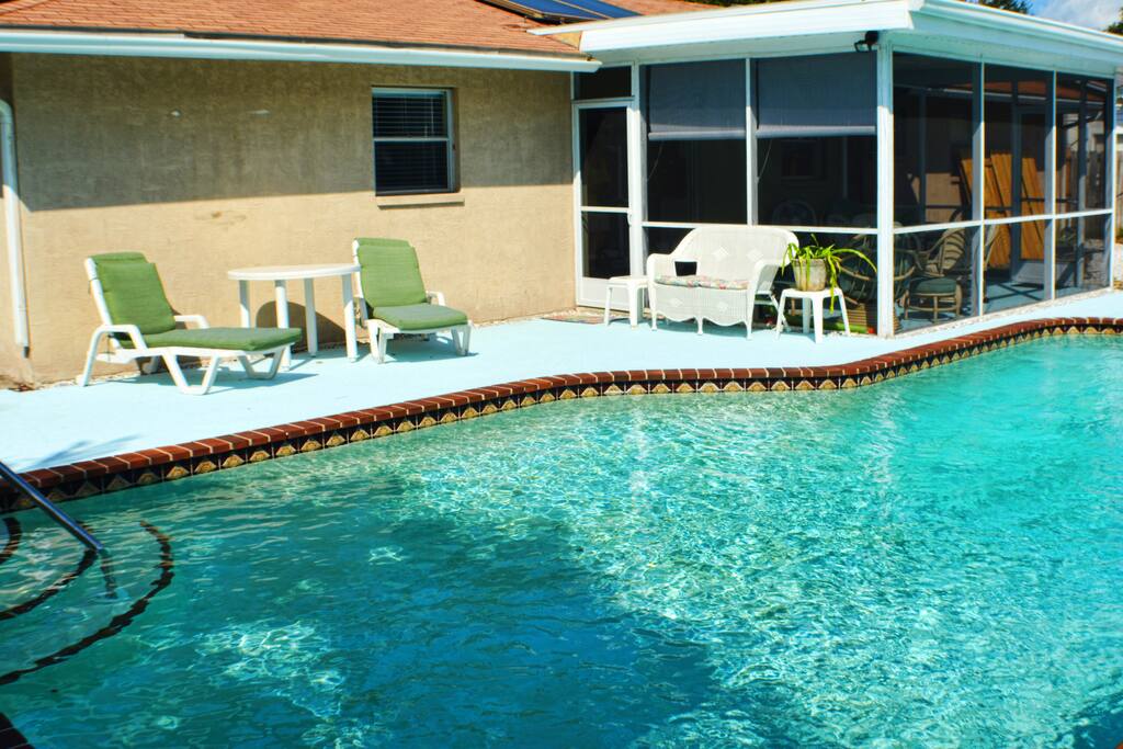 Screen room overlooks pool .