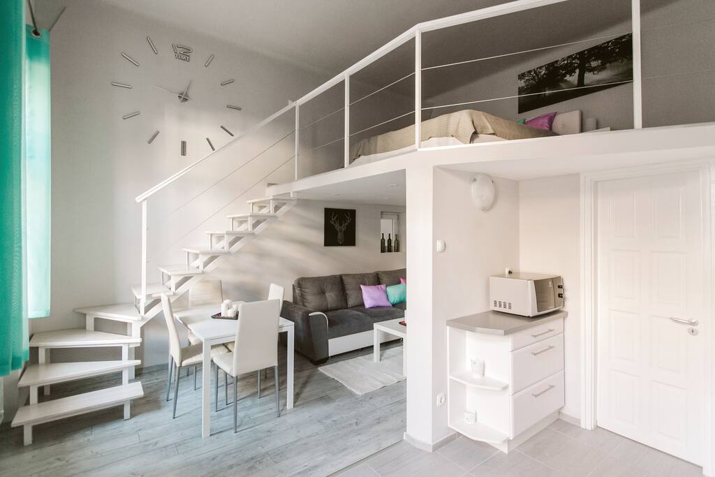 living room, dining area and mezzanine with the entrance to the bathroom from the kitchen