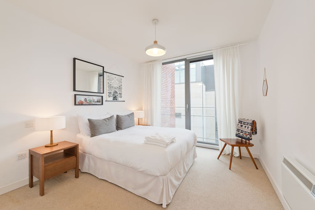Bedroom with designer furniture and hotel grade mattress and freshly laundered sheets