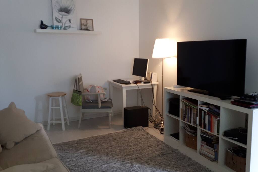 Living room and working desk for computer.