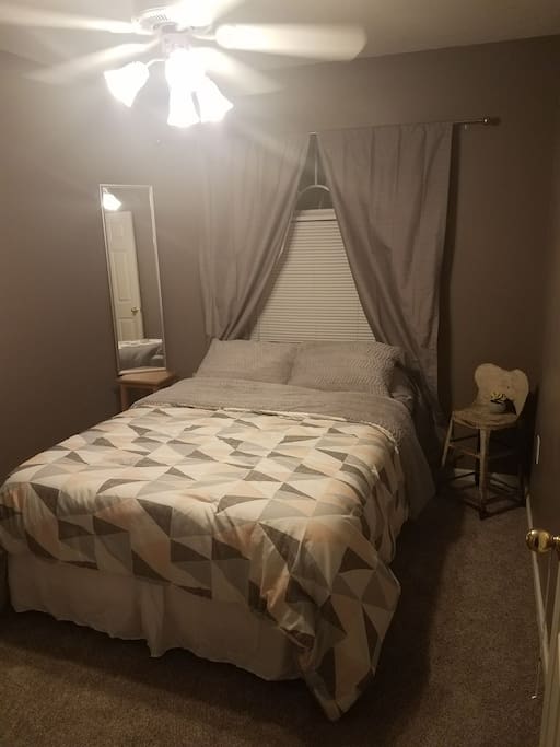 Updated bedroom: new carpet, bedding, paint, and curtains.
