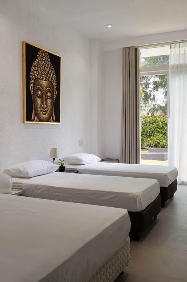 Guest room with one queen bed and two twin beds. The two twin beds can be attached and converted to king size bed with a king mattress. Room include a complete toilet with shower inside.