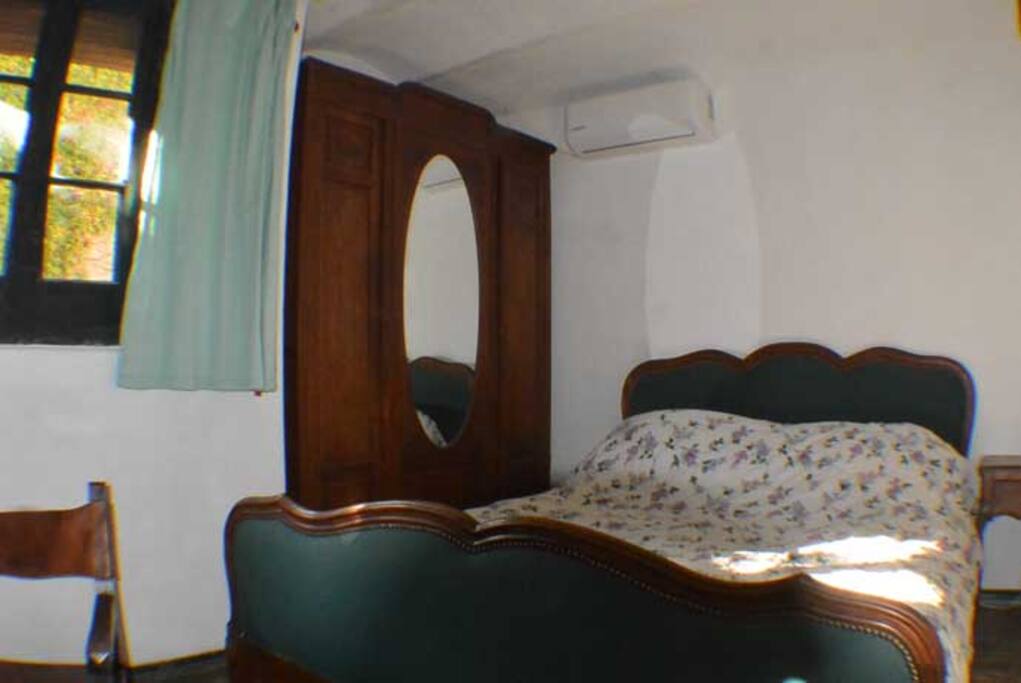 Dormitorio con ventana al balcón.