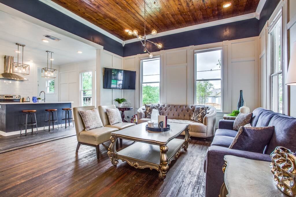 Large open living areas with tall ceilings and original shiplap ceilings