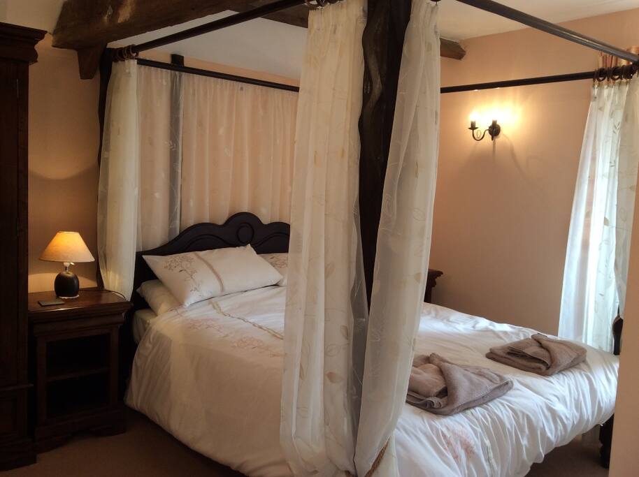 Master bedroom with hand carved four poster