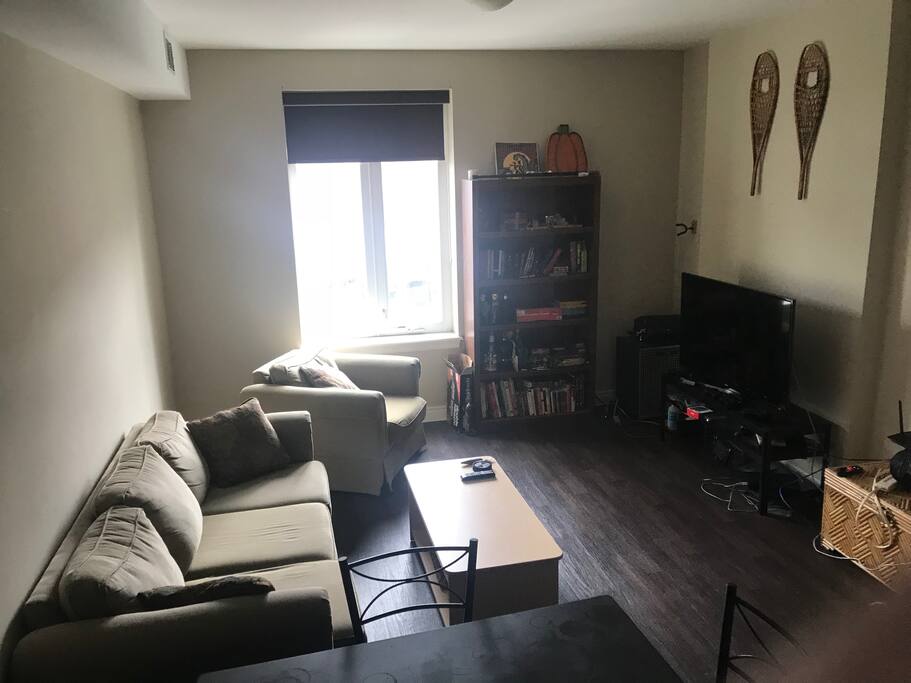 The living room with an open concept kitchen you are welcomed to use. Large couch to lounge in and a TV to use.