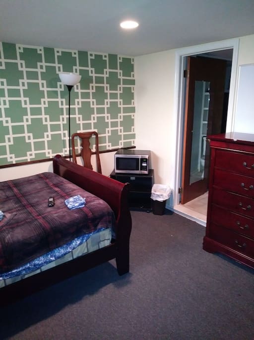 Looking from corner with TV towards opposite corner where microwave & full bathroom entrance are.