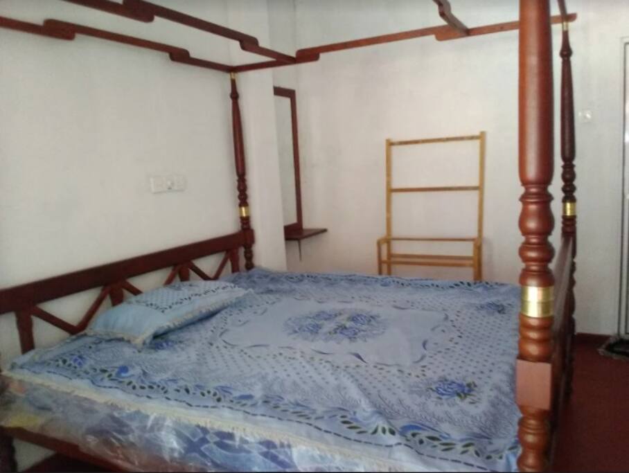 Comfortable Double Bed in each room with cloth hanger & mirror with mosquito net & fan