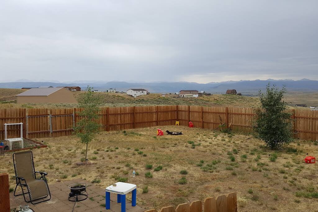 Fenced backyard with fire pit