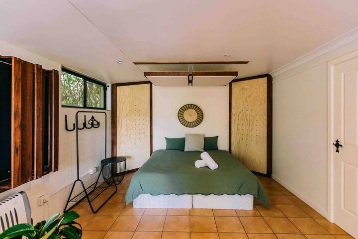 Downstairs bedroom with king size bed, lots of privacy, sound proof and private bathroom with a shower. This room opens up to a small balcony area overlooking the pool. It has a office desk and comfortable leather couch to rest and relax in style.
