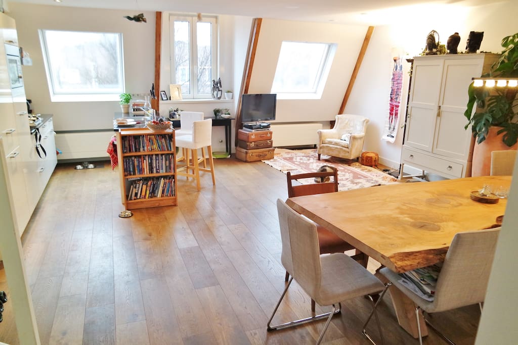 fourth floor with open kitchen, big dinner table, tv corner.