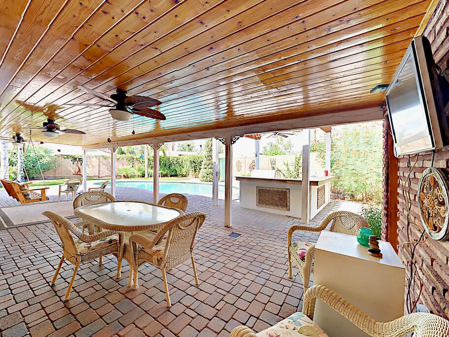 The impressive patio with outdoor seating, kitchen and flat screen TV.
