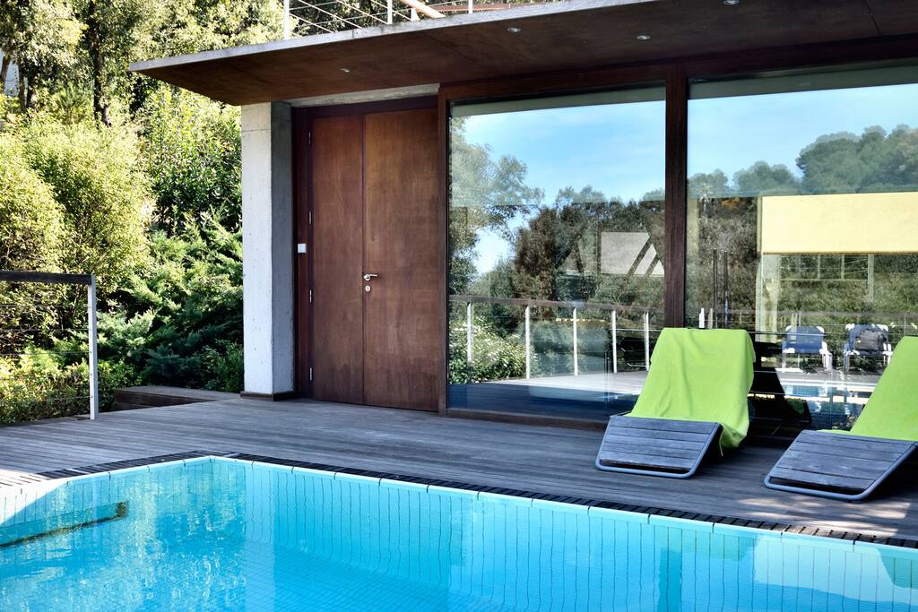 Piscina privada con terraza con tumbonas y mesa para comer en el exterior