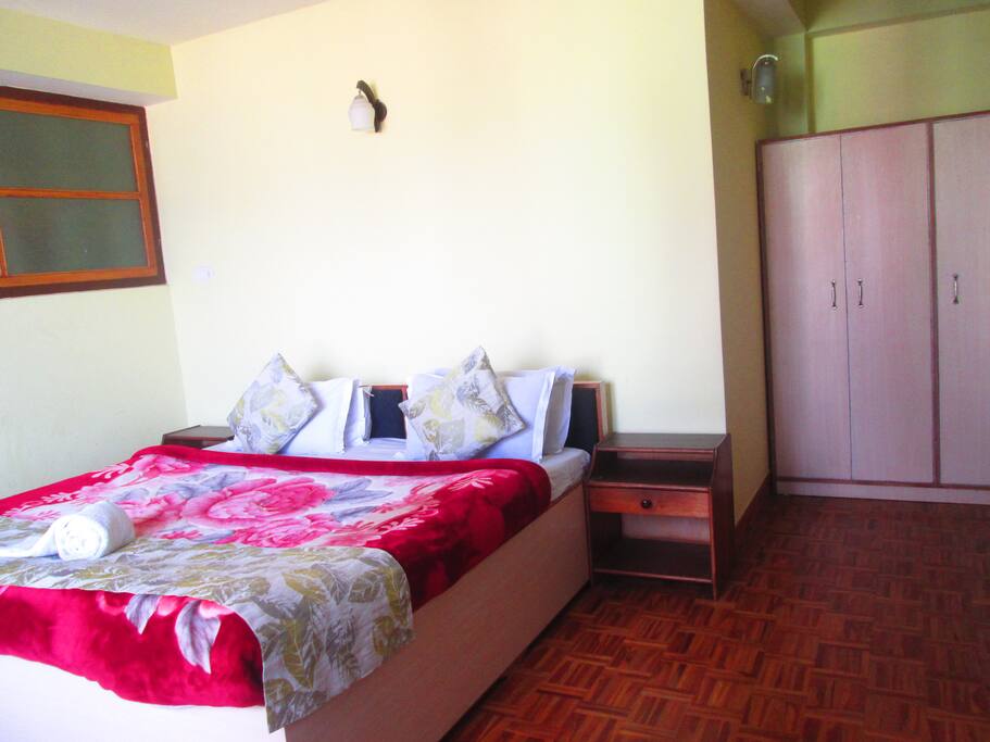 Queen sized bed with side tables and wardrobe