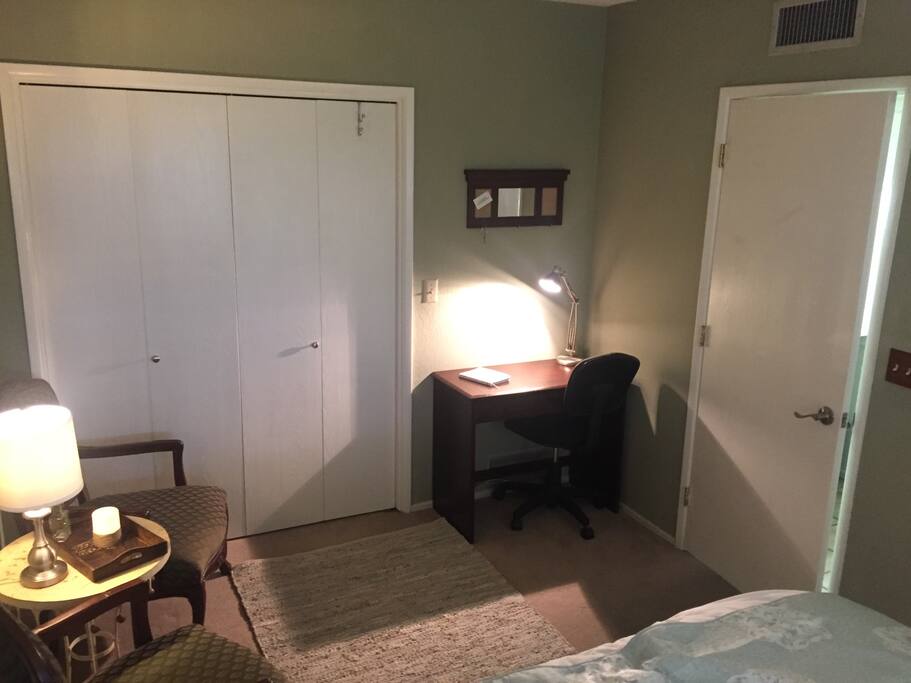 Work desk with drawer, chair and lighting.