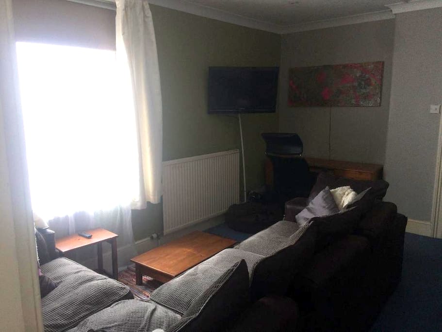 Lounge area with desk and TV