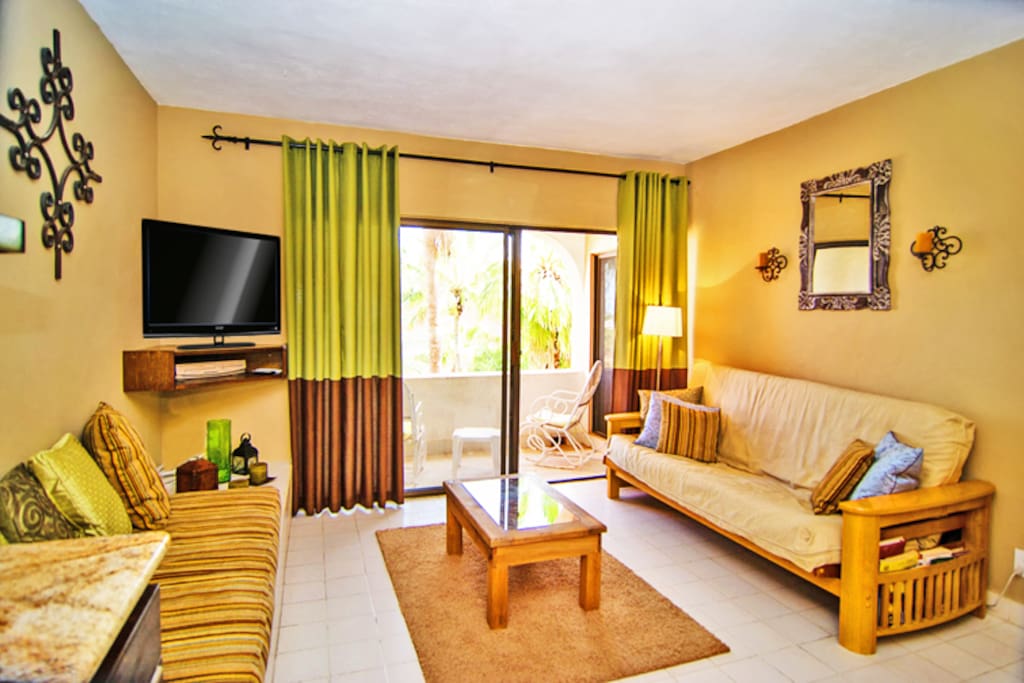 Living room with 42" flatscreen TV, DVD player, and a fold-out futon for additional sleeping for guests.