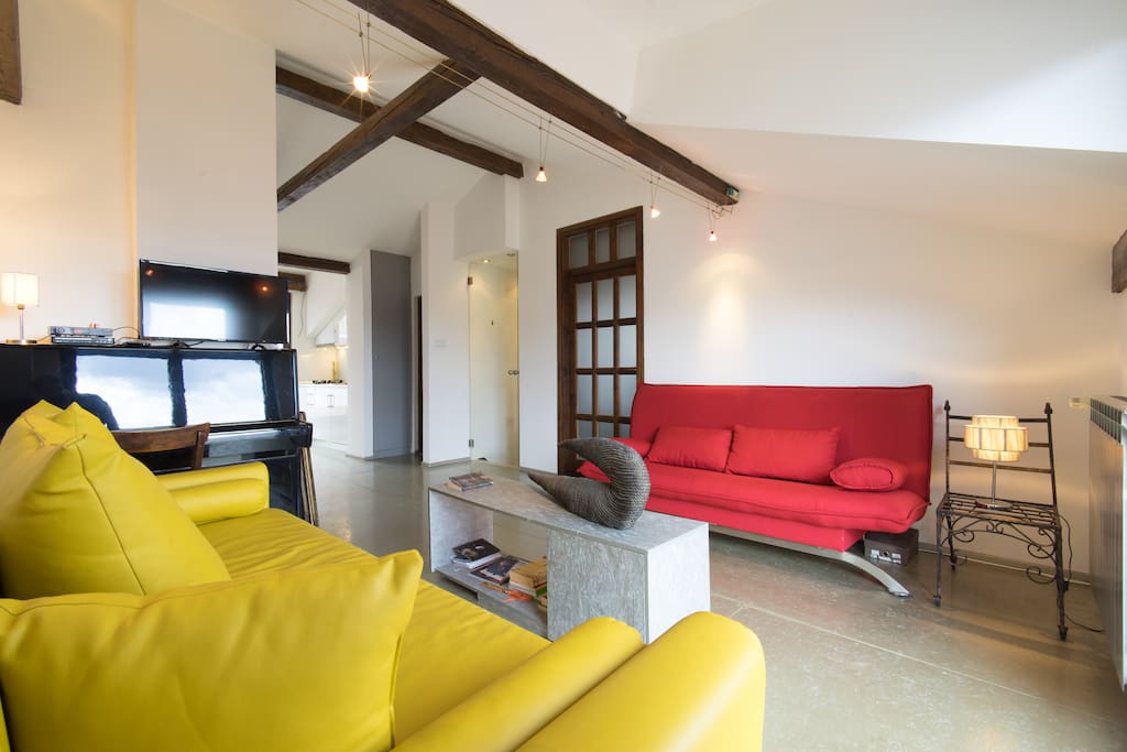 Living room with two sleeper-sofas and an upright piano