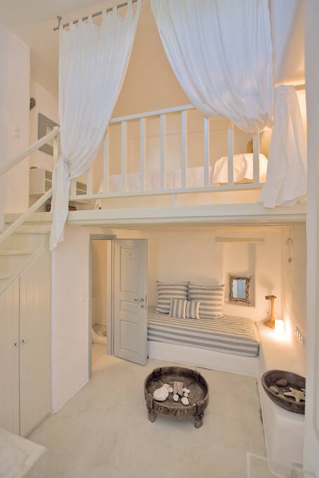 The main room, with a double bed on the upper floor and a single on the lower