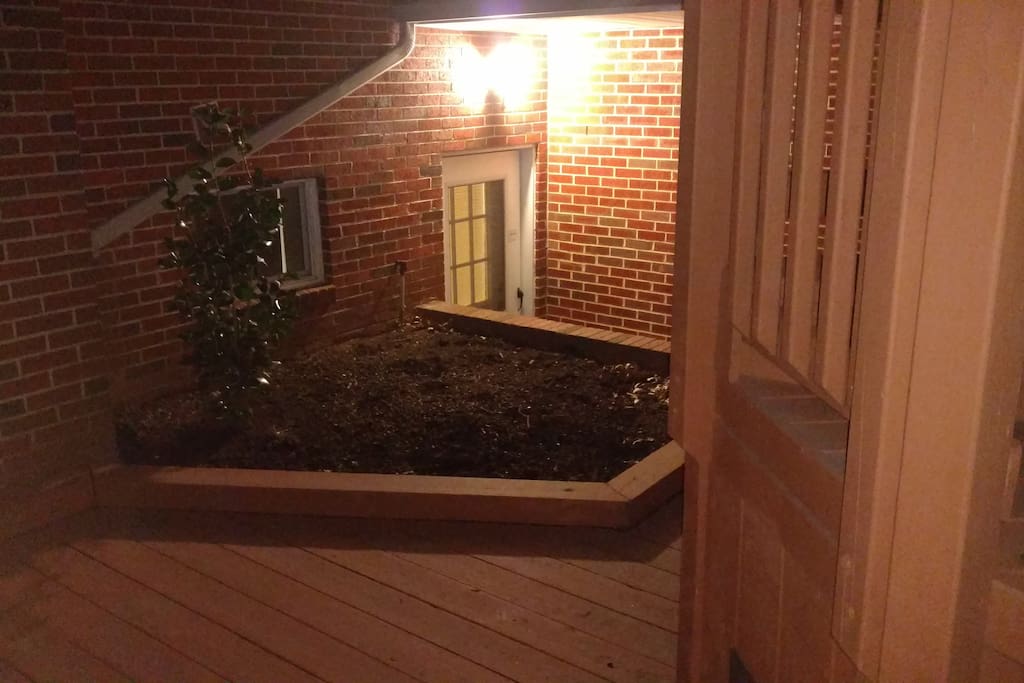 Wooden deck leading to stairs for basement apartment .