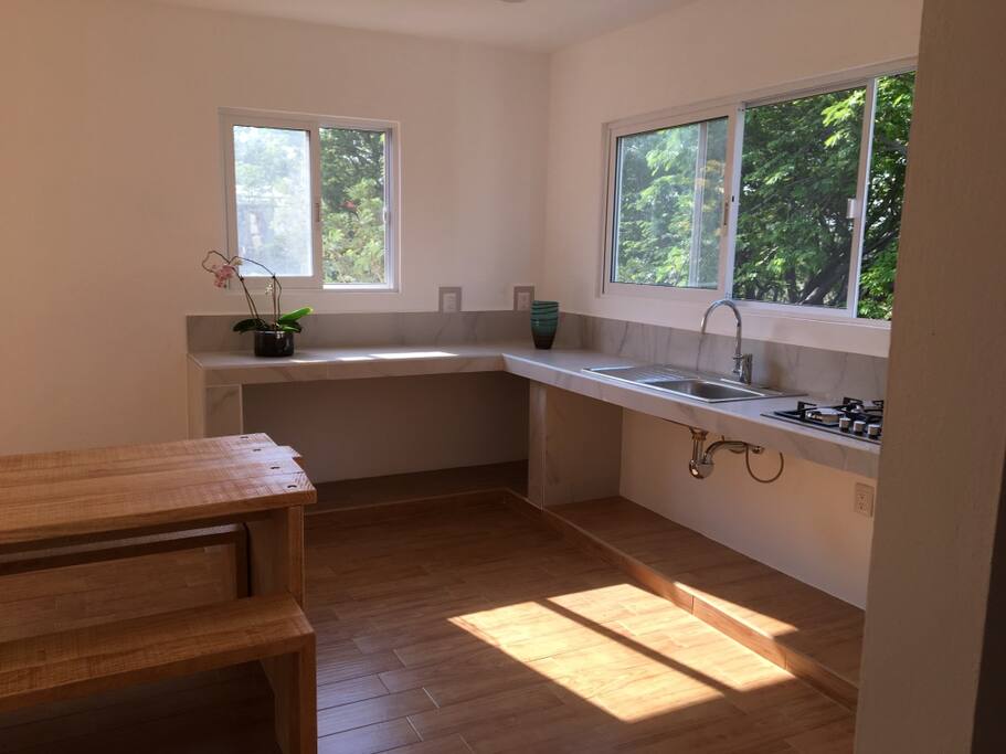 Views from the kitchen to the pool and gardens.