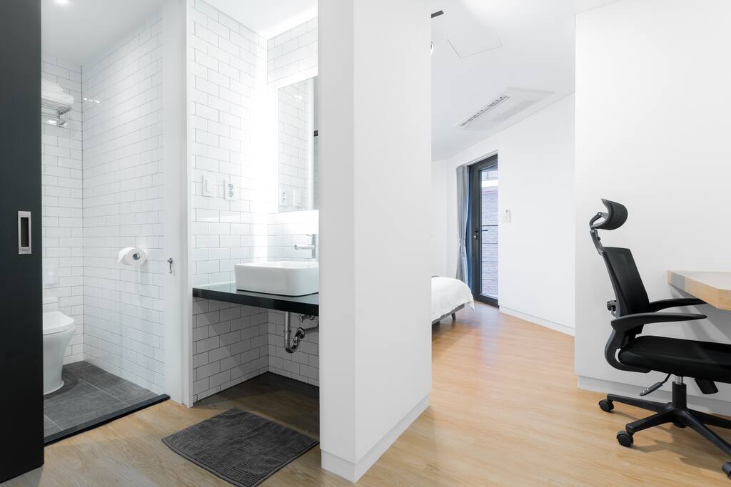 Each room features a comfy queen bed, work space, closet, balcony, and a bathroom.