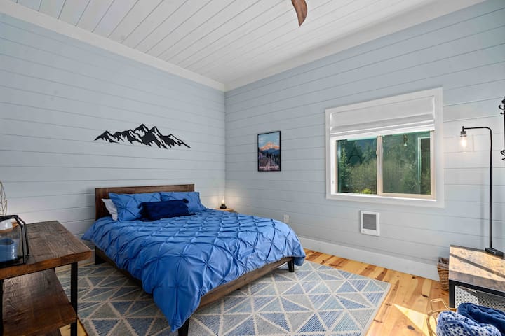 Primary bedroom with ceiling fan and wall mounted heater