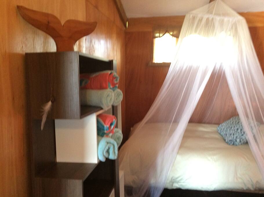 The room, one of the 2 twin beds, artistic place to store personal items
