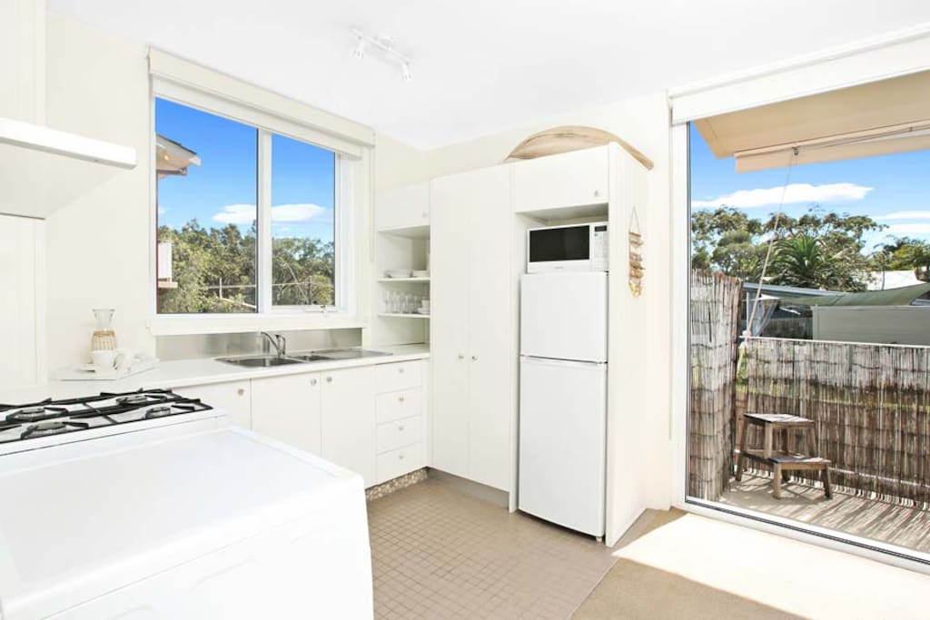 Delightful kitchen with oven, cooktop, fridge, microwave and every tool you'll need to cook.