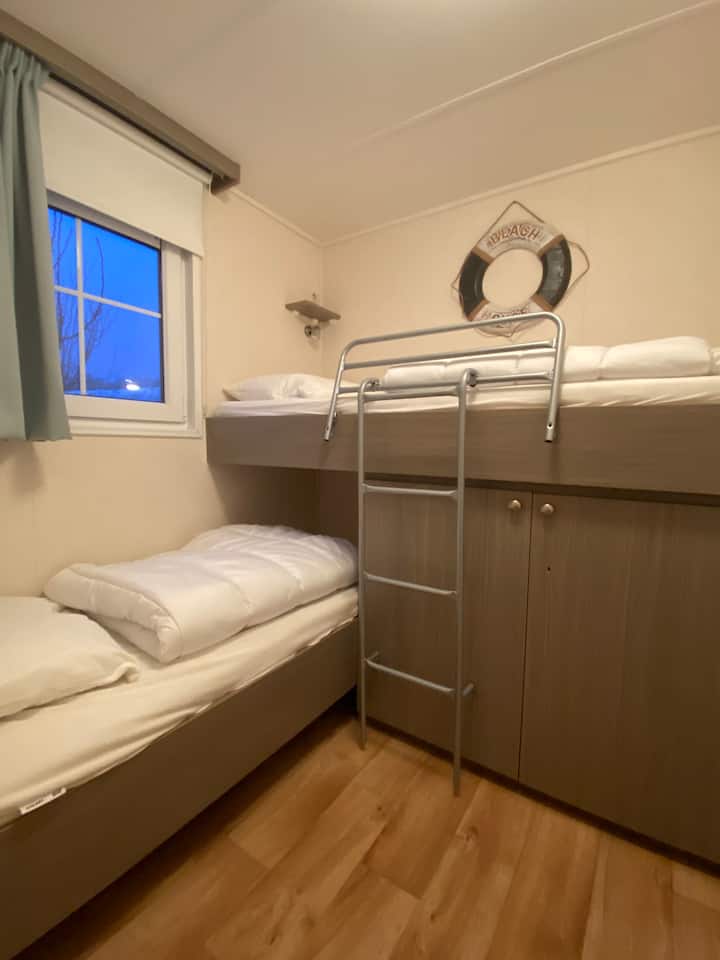 Bedroom with bunk bed and blackout curtains and blinds
