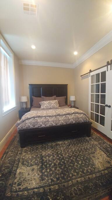 King Bed, to the right is the bathroom and to the left are the windows overlooking Norris Park.