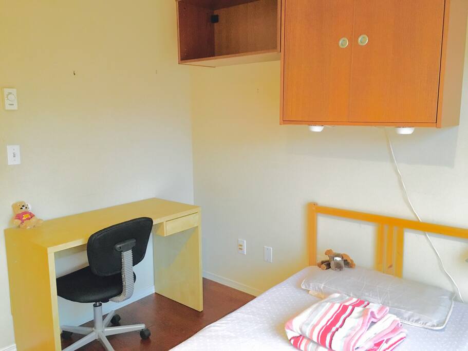 Private bedroom with bed and desk