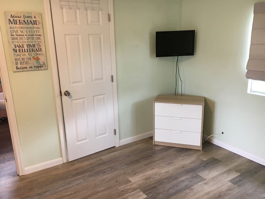 Cable TV with movie channels, laundry room and small dresser.