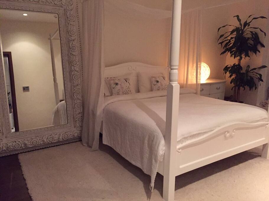 All White Calm Bedroom With King Size Bed Overlooking the Ocean With EnSuite Bathroom with full amenities including his & her sinks, large bath tub, spacious walk in shower, bidet and toilet.