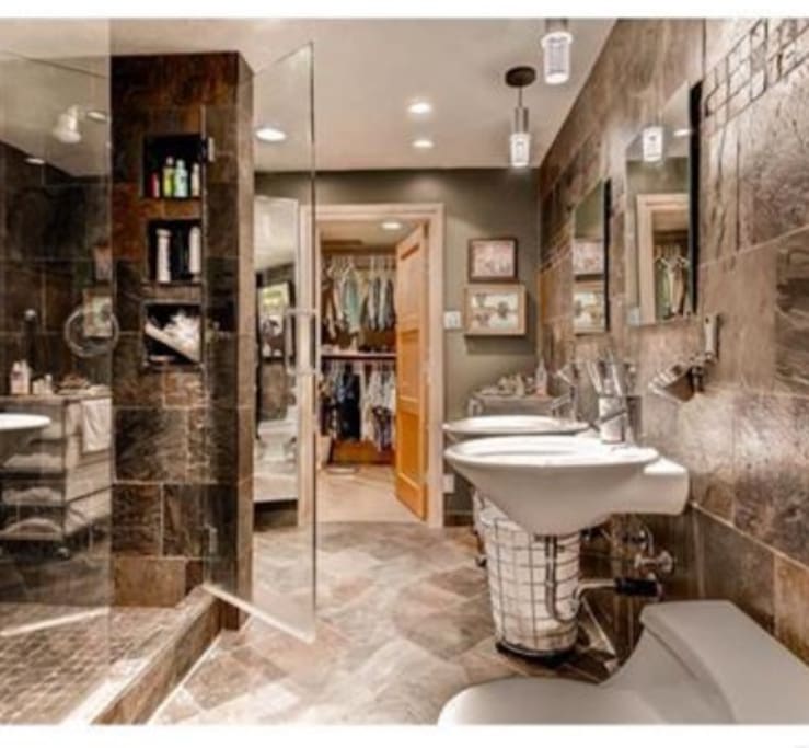 spectacular remodeled bathroom with dual shower heads and sinks and three view mirror