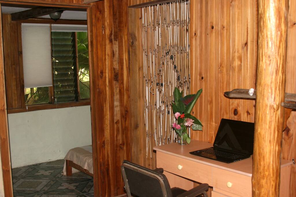 Desk, part of living space, doorways to bedrooms