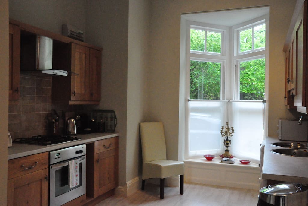 Large kitchen with washing machine, gas hob and electric fan oven