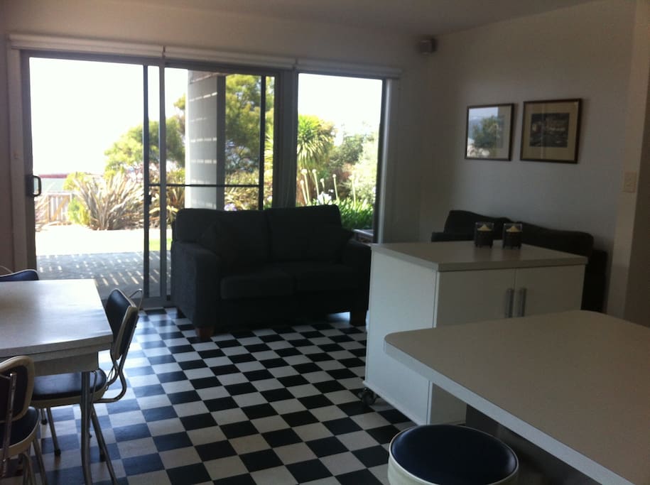 Relax in the combined living/dining space. Watch a bit of tv or read a book while listening to the soothing sounds of the ocean.