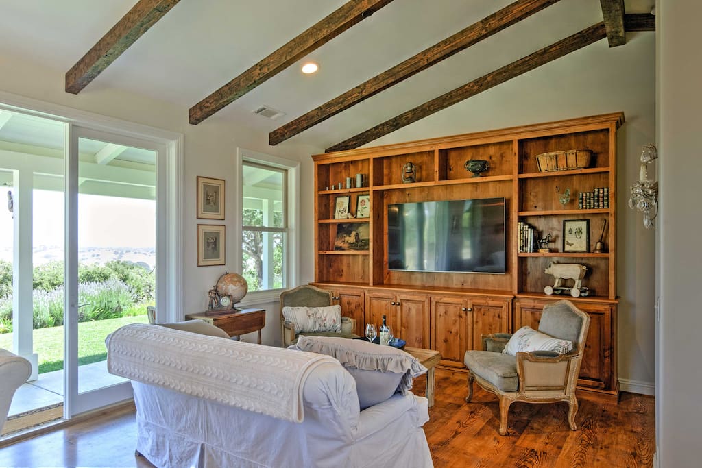 Wood beams, stunning views, and French country style decor adorn the interior of the property.