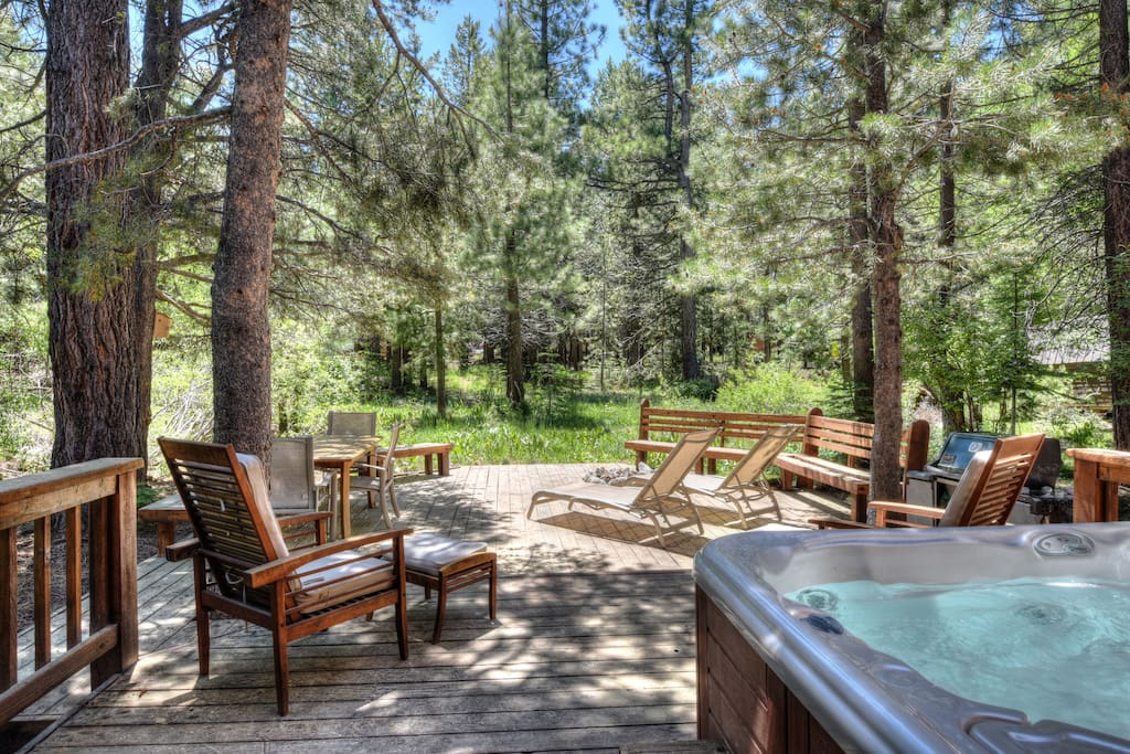 Back deck with a grill, fire-pit, and hot tub
