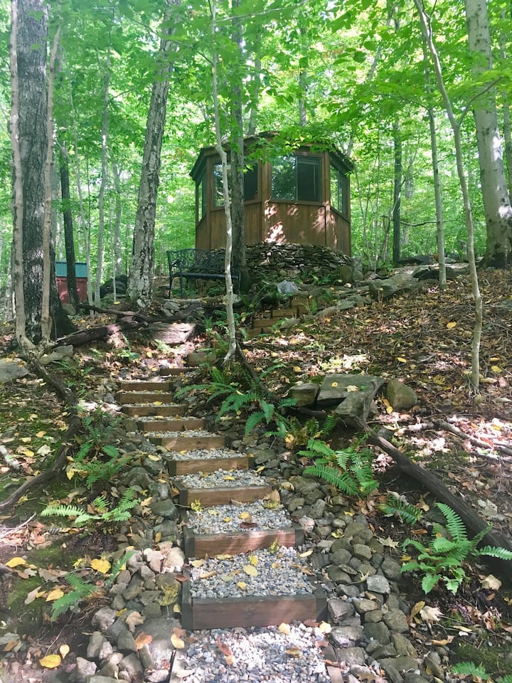 Stone steps lead to an octagonal Airbnb in New England