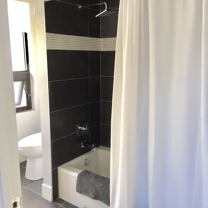 Bathroom with rain shower head and tub