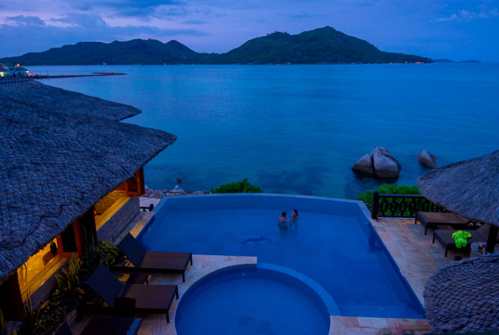 POOL NEAR SEA AND RESTAURANT NIGHT TIME