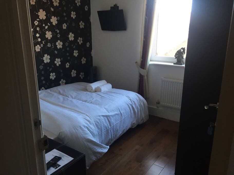 Double Bed and Side Cabinet with 24" HDTV on wall connected to Freeview Channels