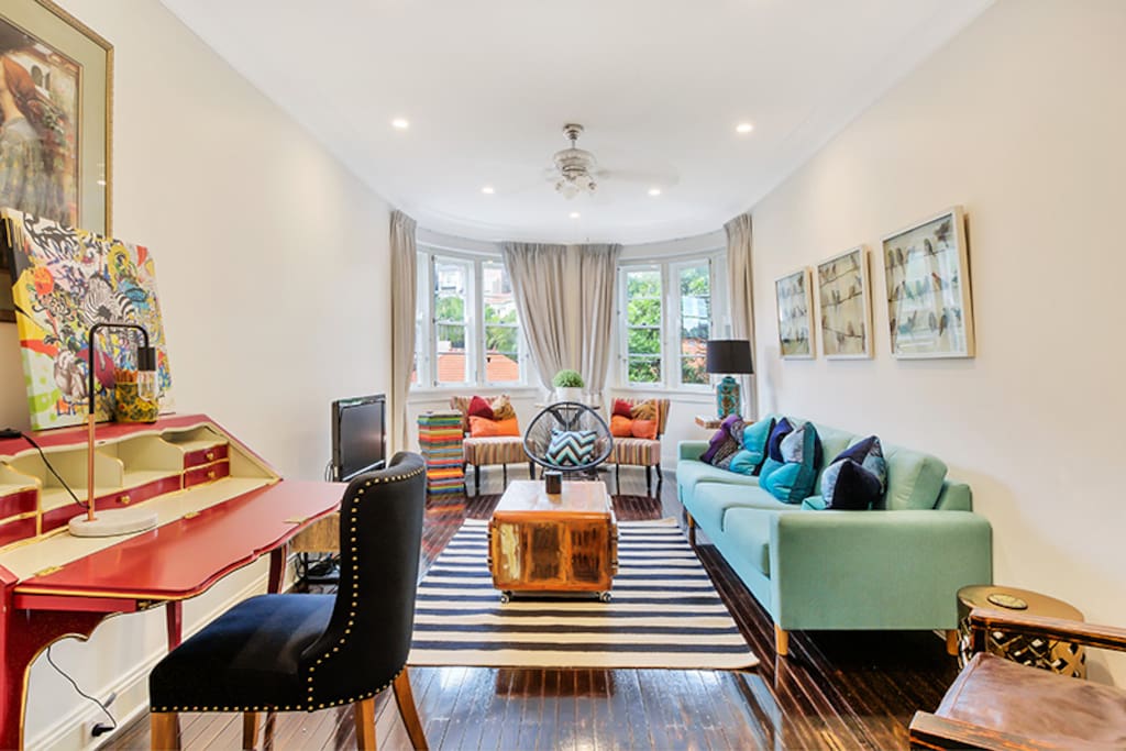 Living Rooms with curved features, designer furniture and green district views.
